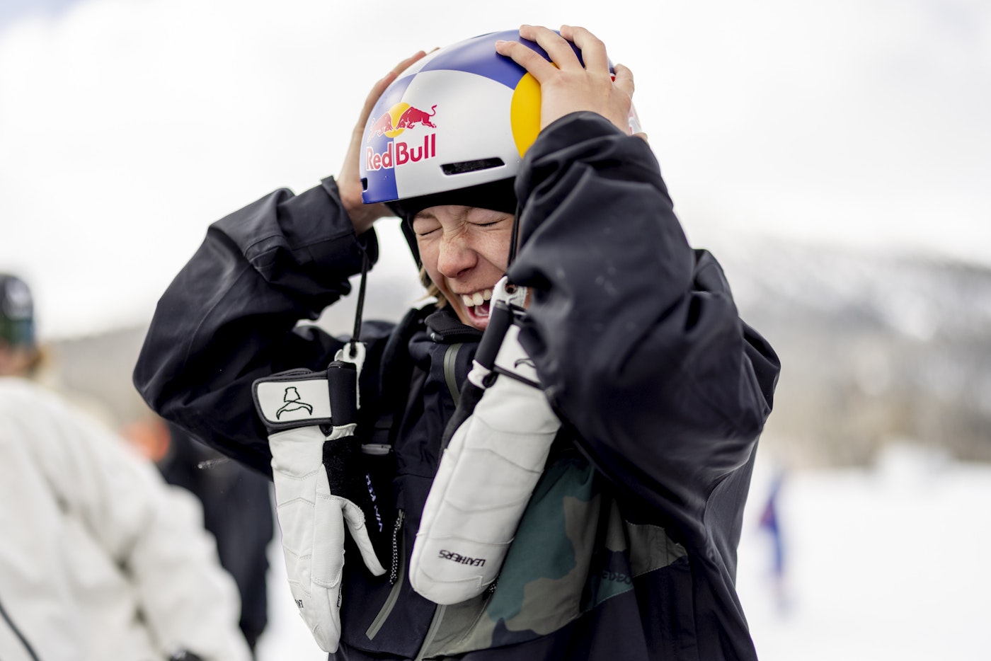Skier Walker Woodring smiling and grabbing her helmet