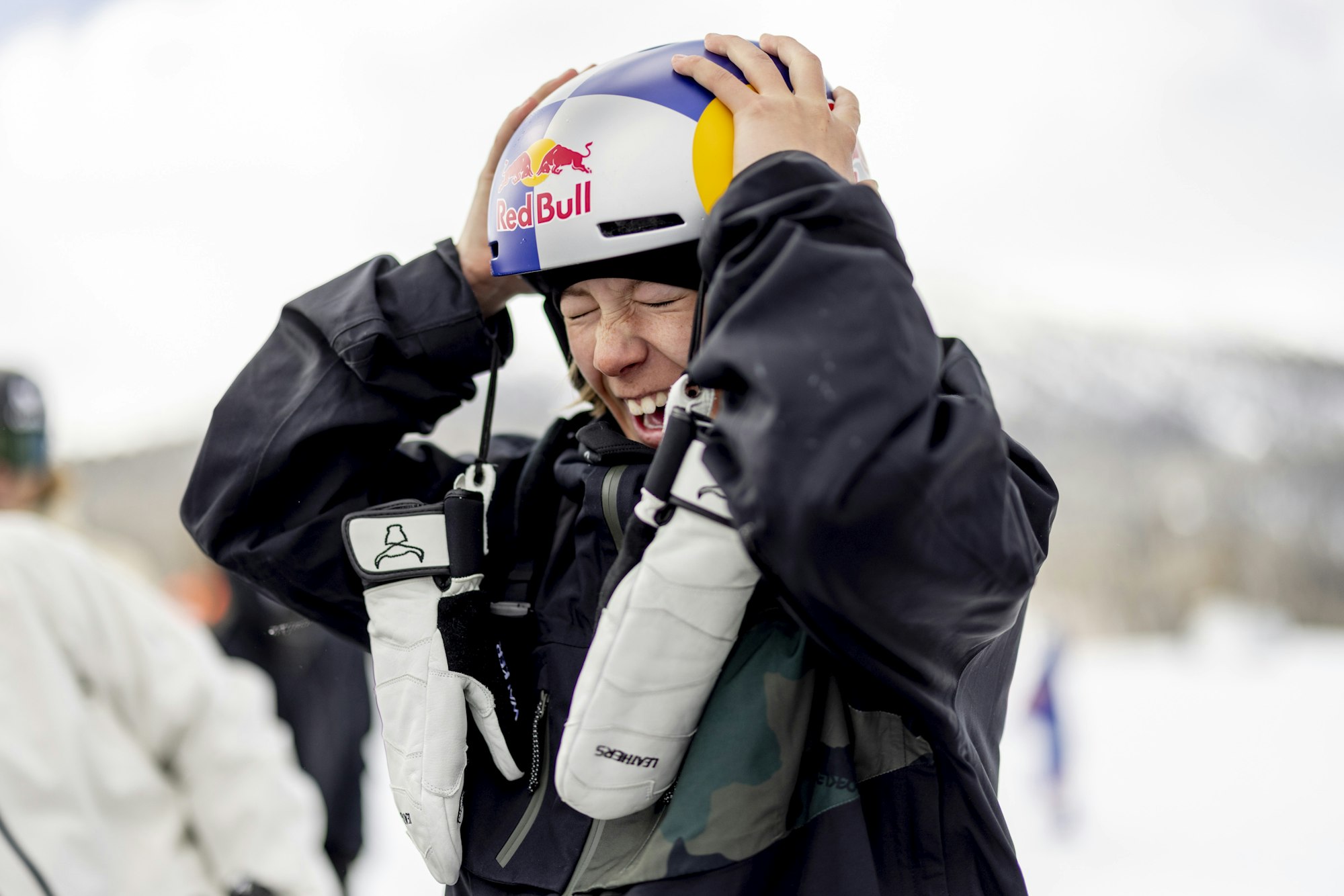 Skier Walker Woodring smiling and grabbing her helmet