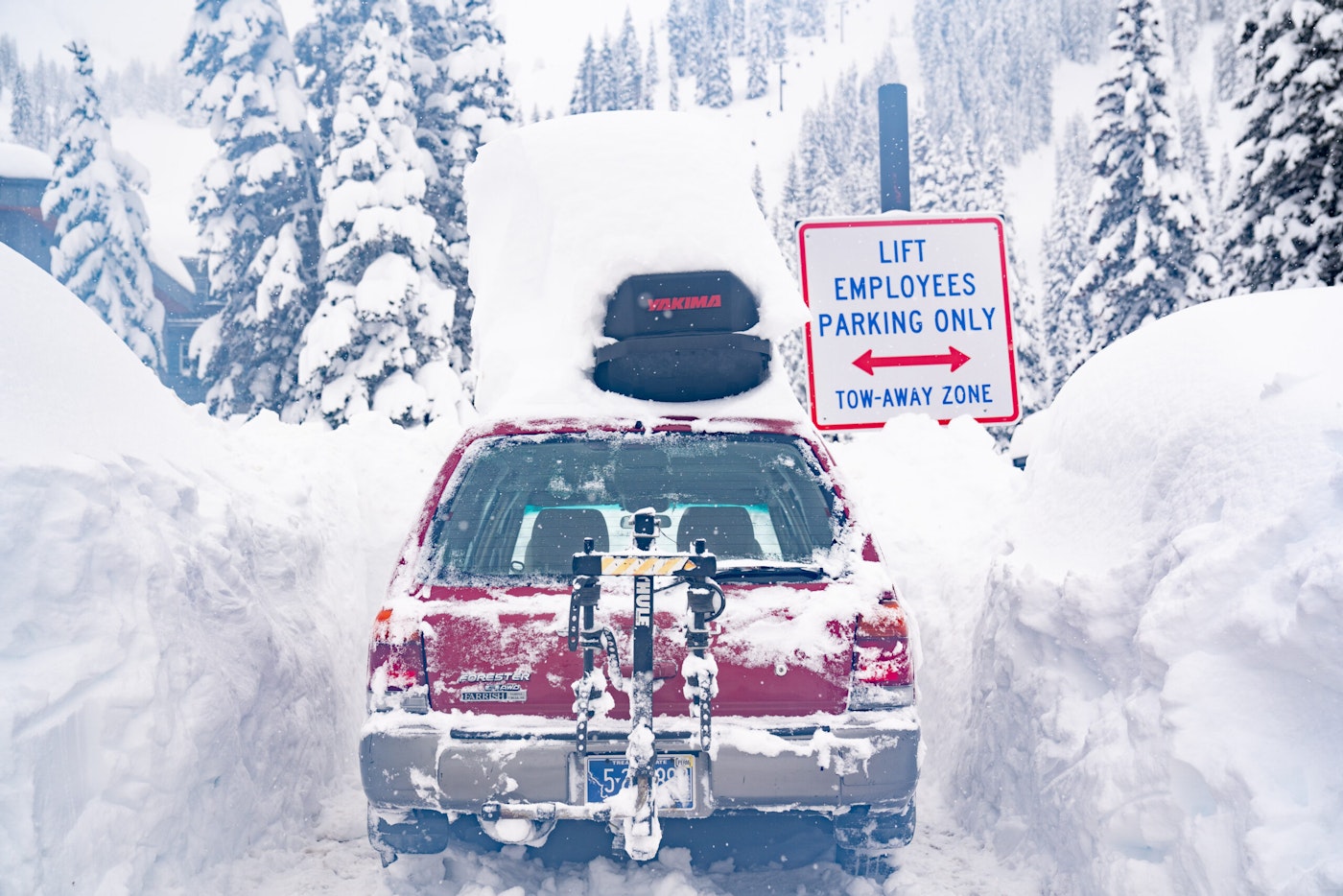 A snow covered car in the Alta Ski Area parking lot