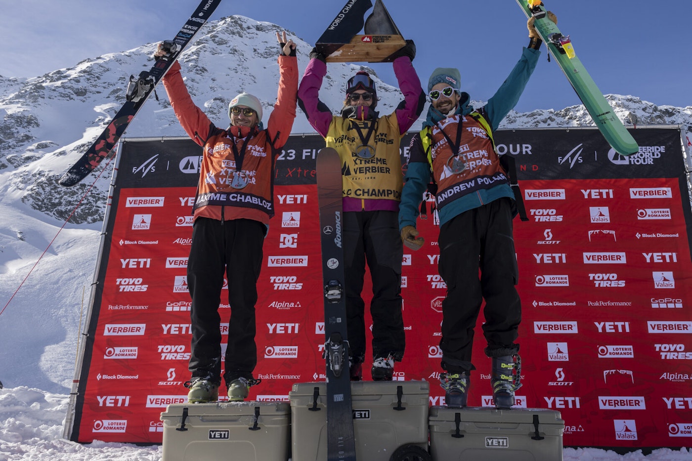 Men's freeride world tour skiers posing on the podium