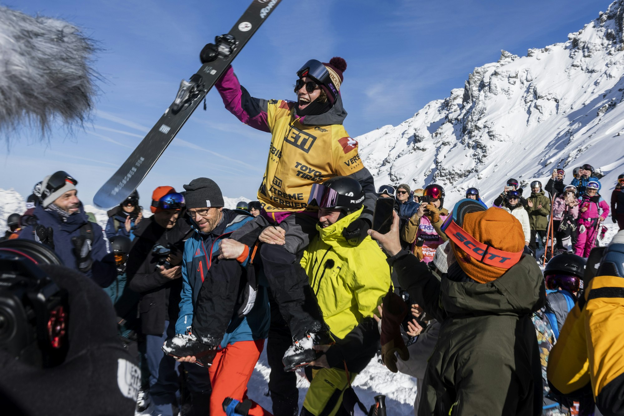 Freeride World Tour champion Valentin Rainer carried in a crowd with one ski