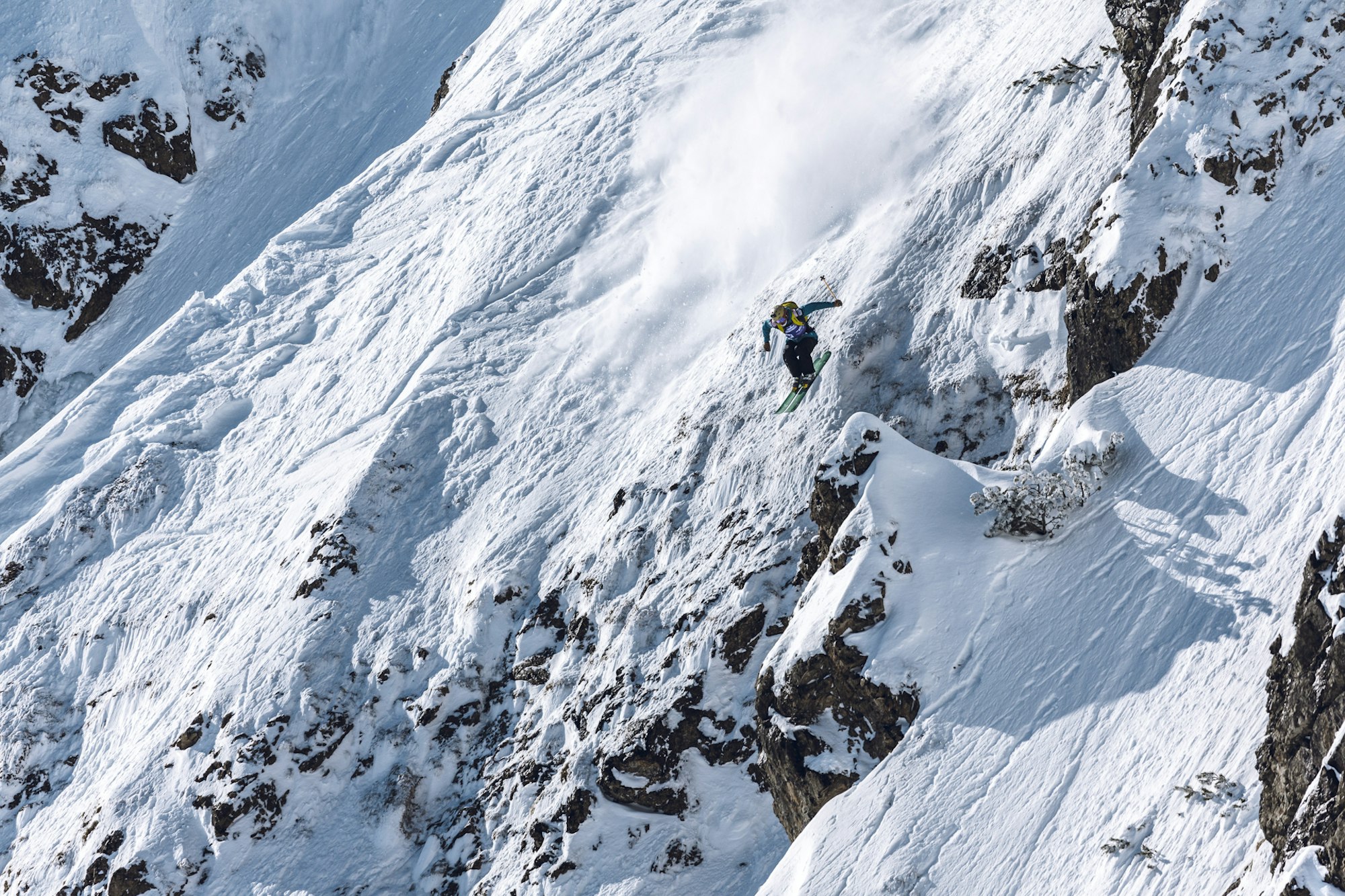 Freeride World Tour jumping off a rocky section of a face