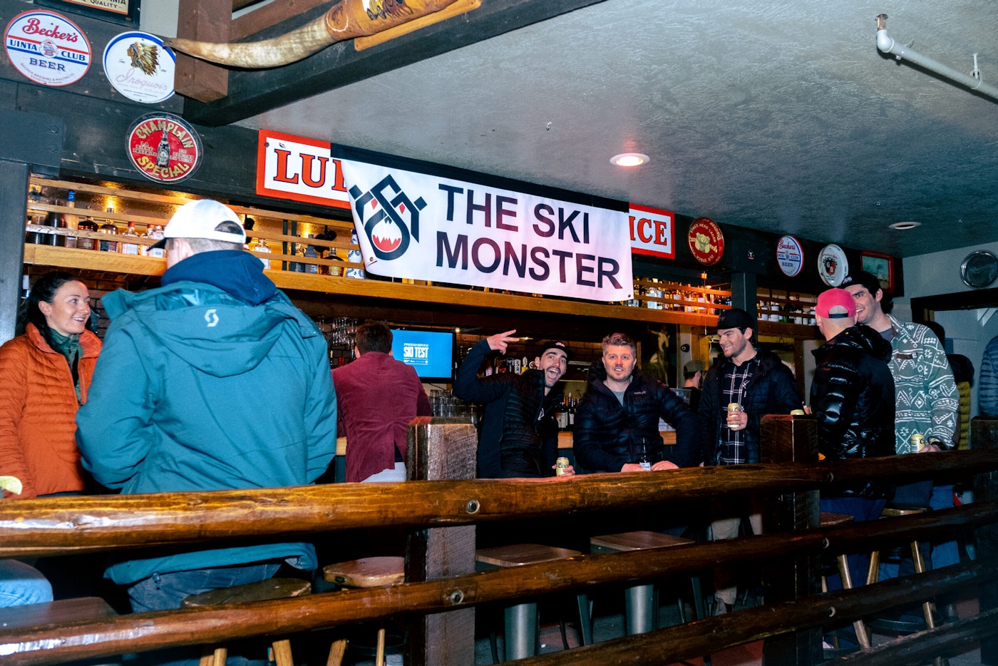 a group of people posing for a photo at a bar