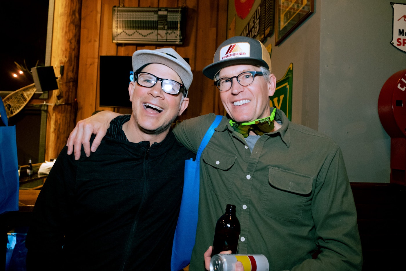 two men posing for a photo at a bar