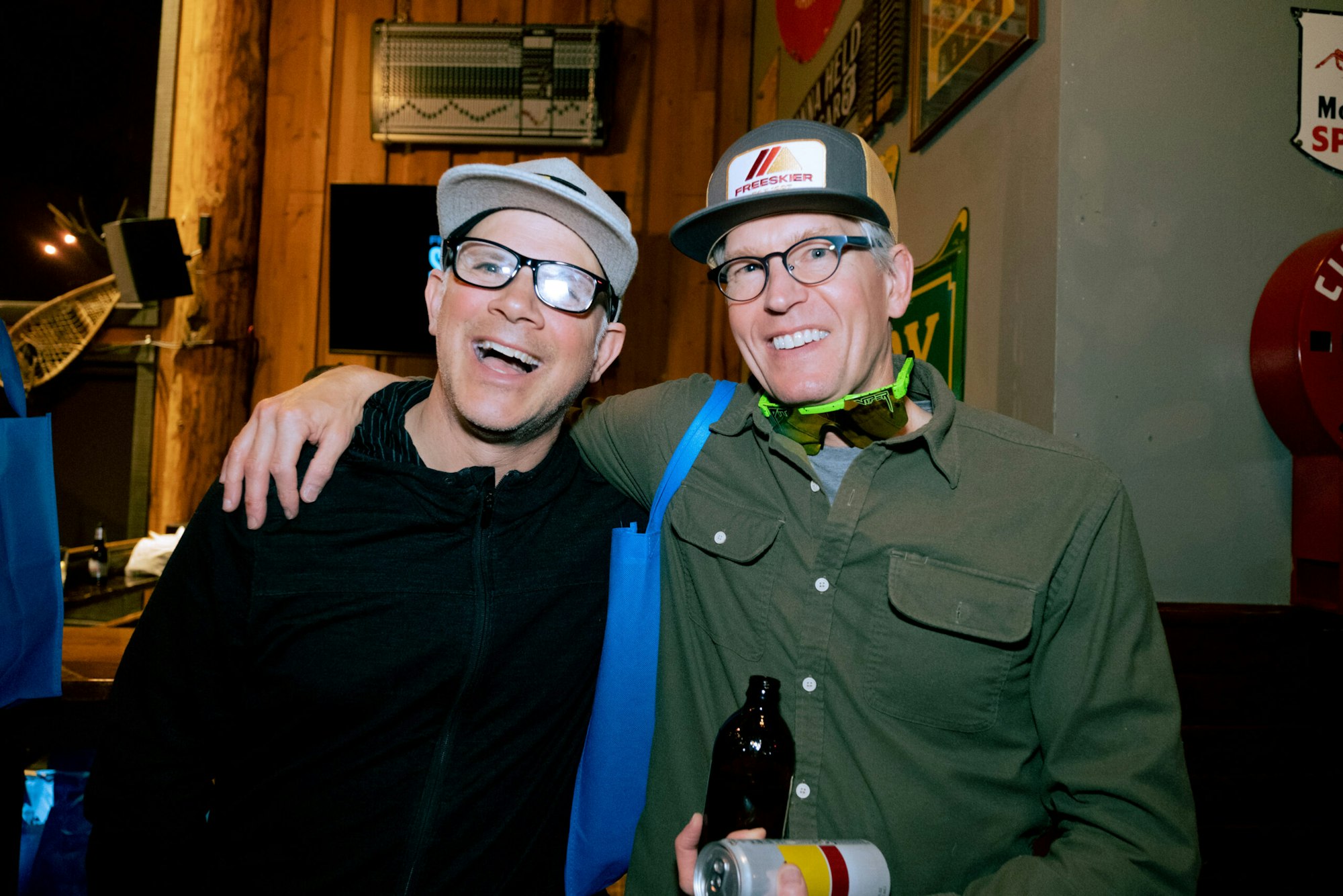 two men posing for a photo at a bar