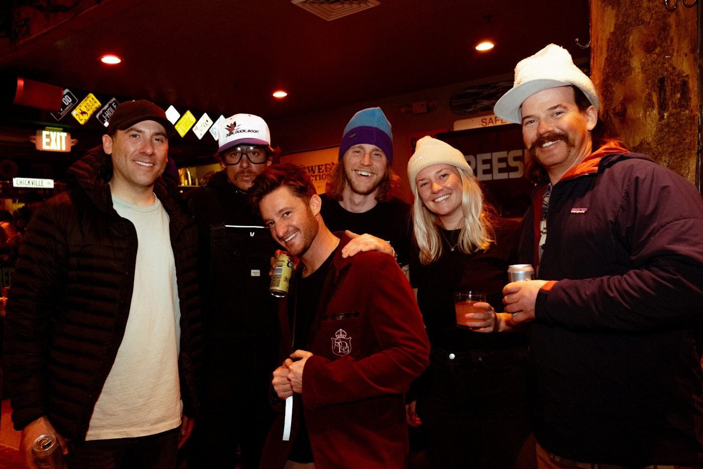 A group of people poses for a picture in a bar