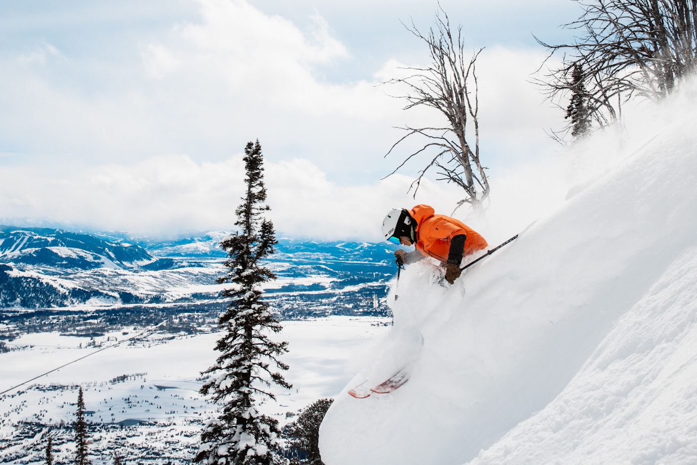 A skier makes a sharp turn in deep snow