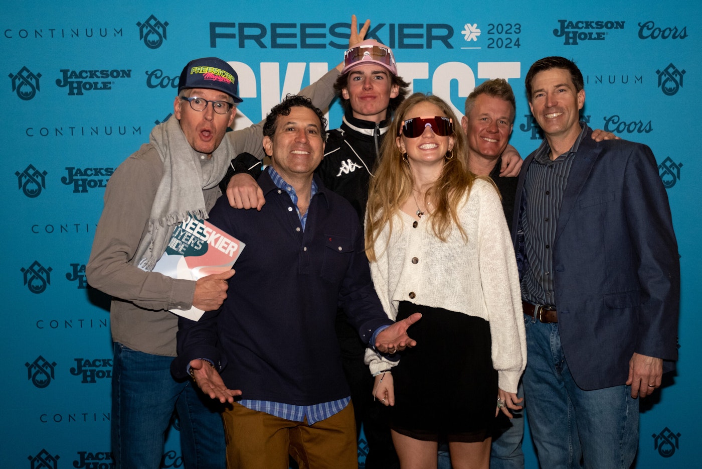 6 people pose in front of FREESKIER banner