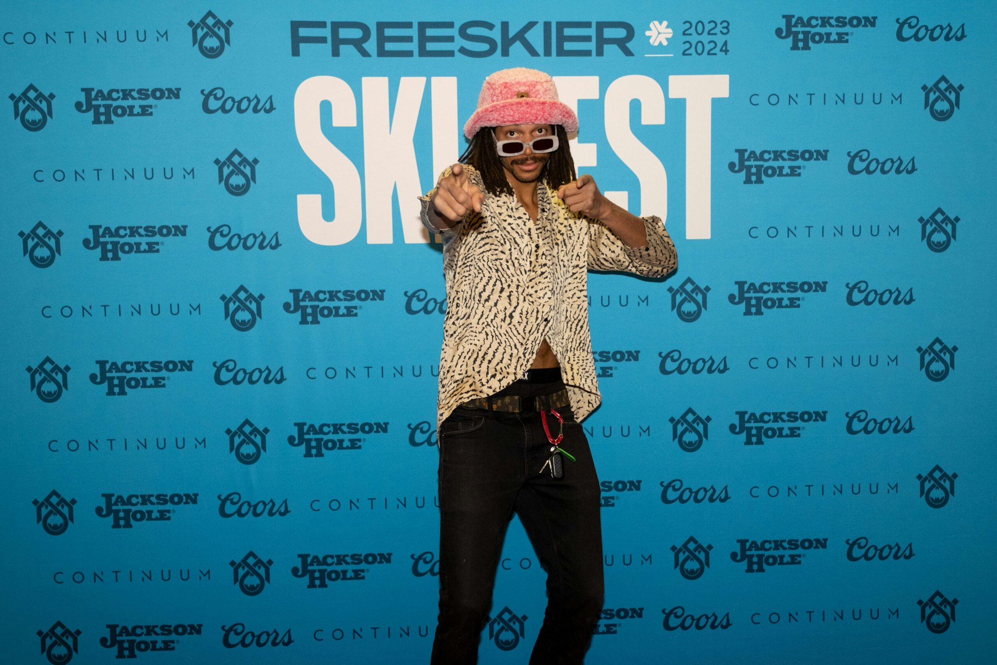 Person poses in front of FREESKIER banner