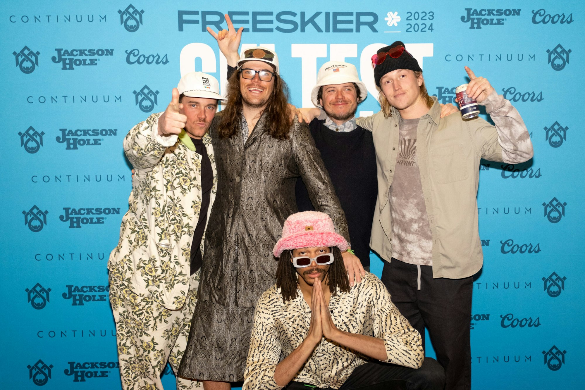 five people pose in front of FREESKIER banner