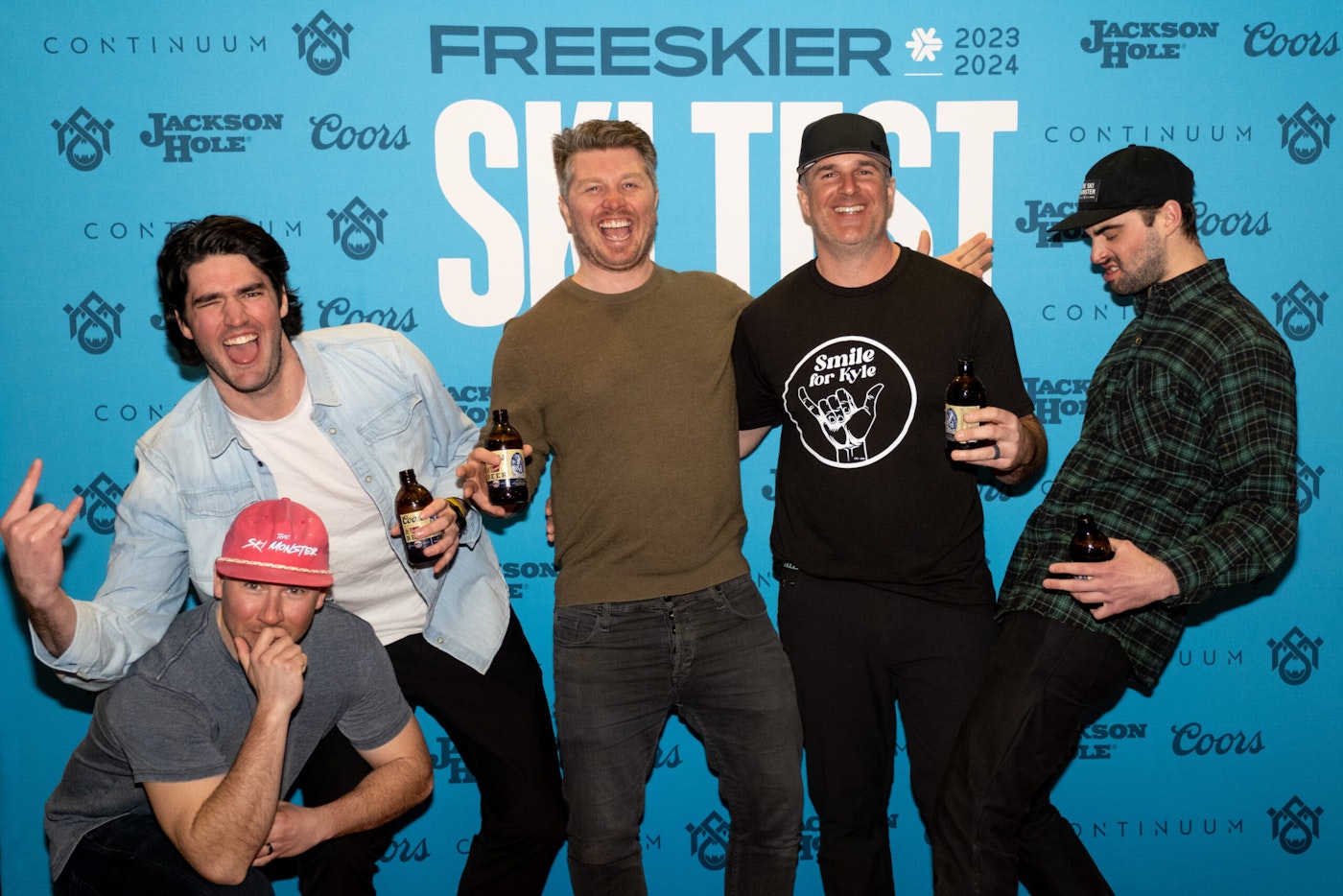 Five people pose in front of FREESKIER banner