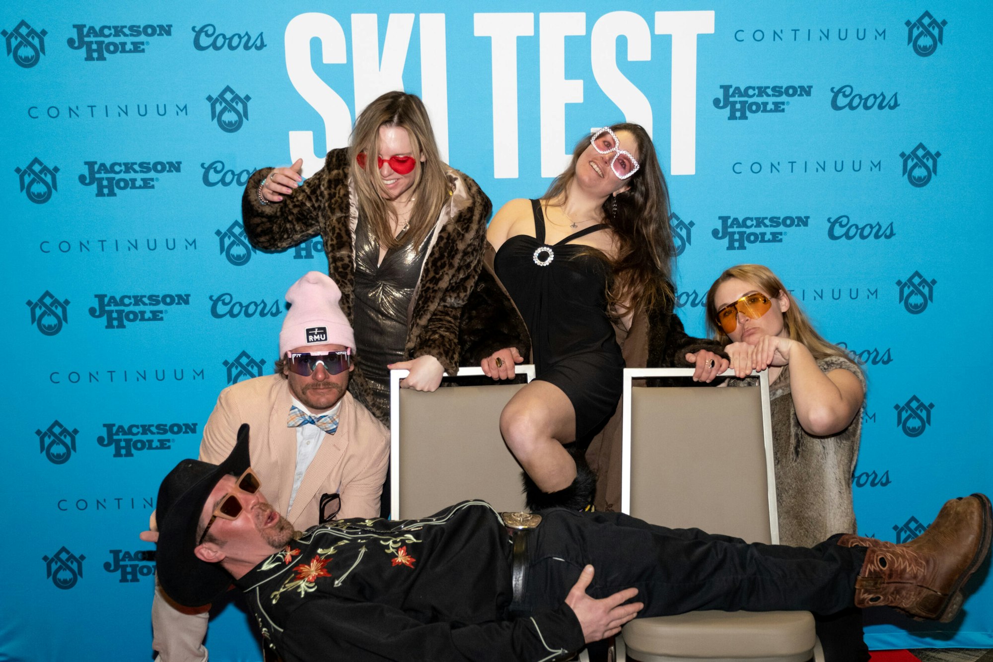 Five people pose in front of FREESKIER banner