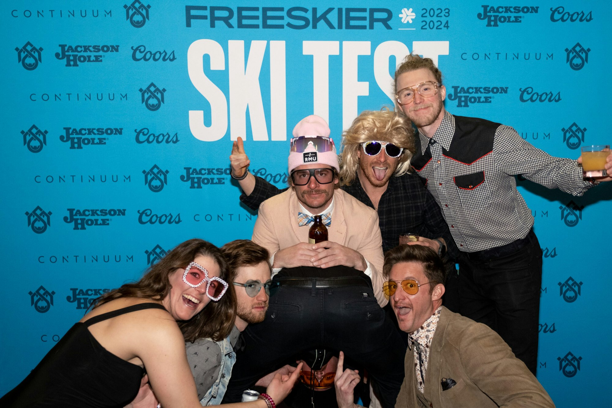 six people pose in front of FREESKIER banner