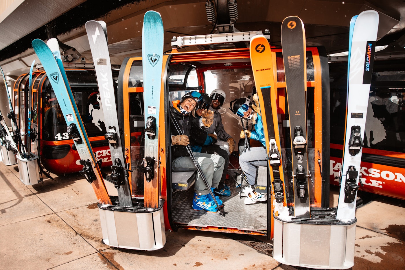 Skiers smile from inside a gondola at Jackson Hole Mountain Resort
