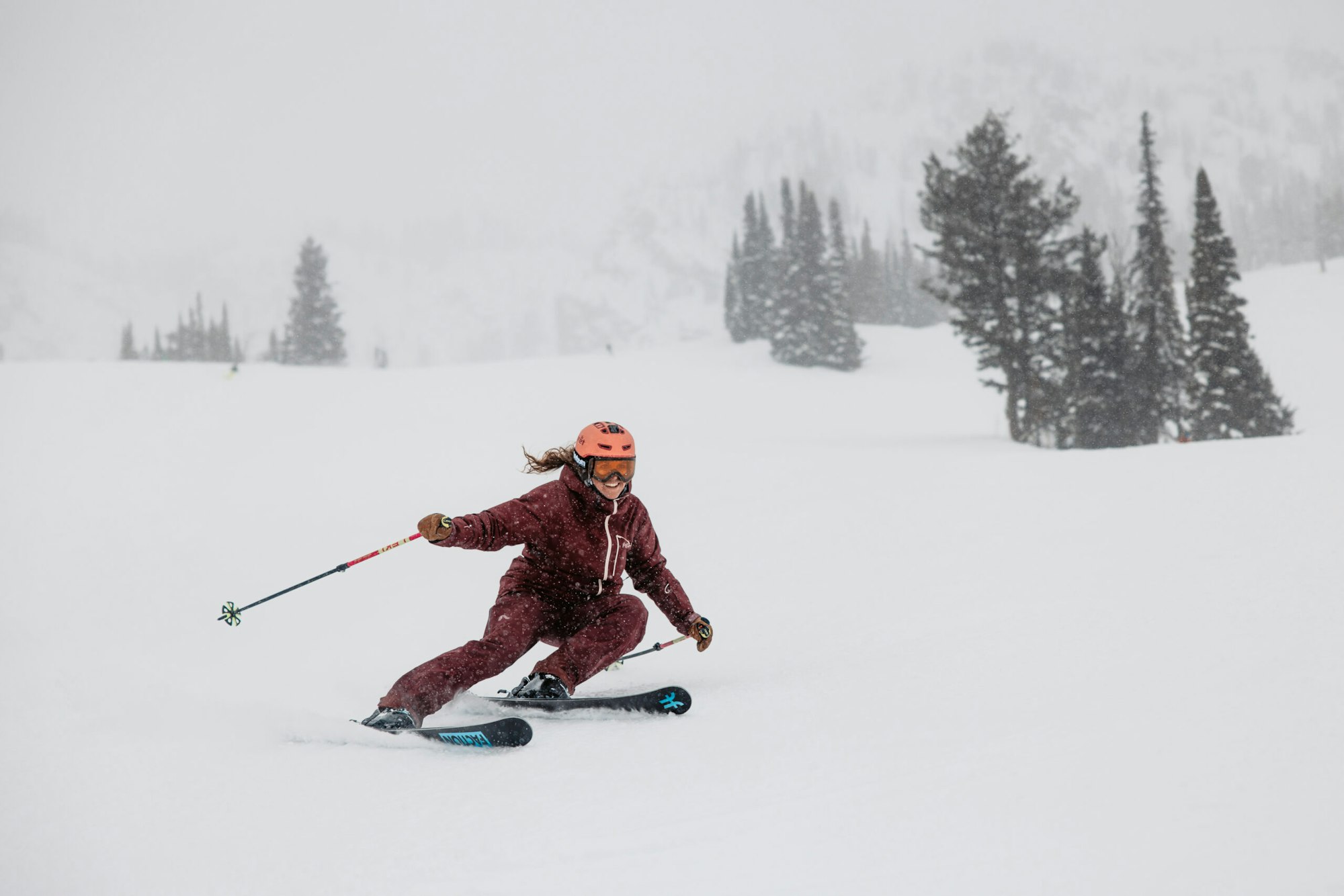 Skier turns through snow in a snowstorm