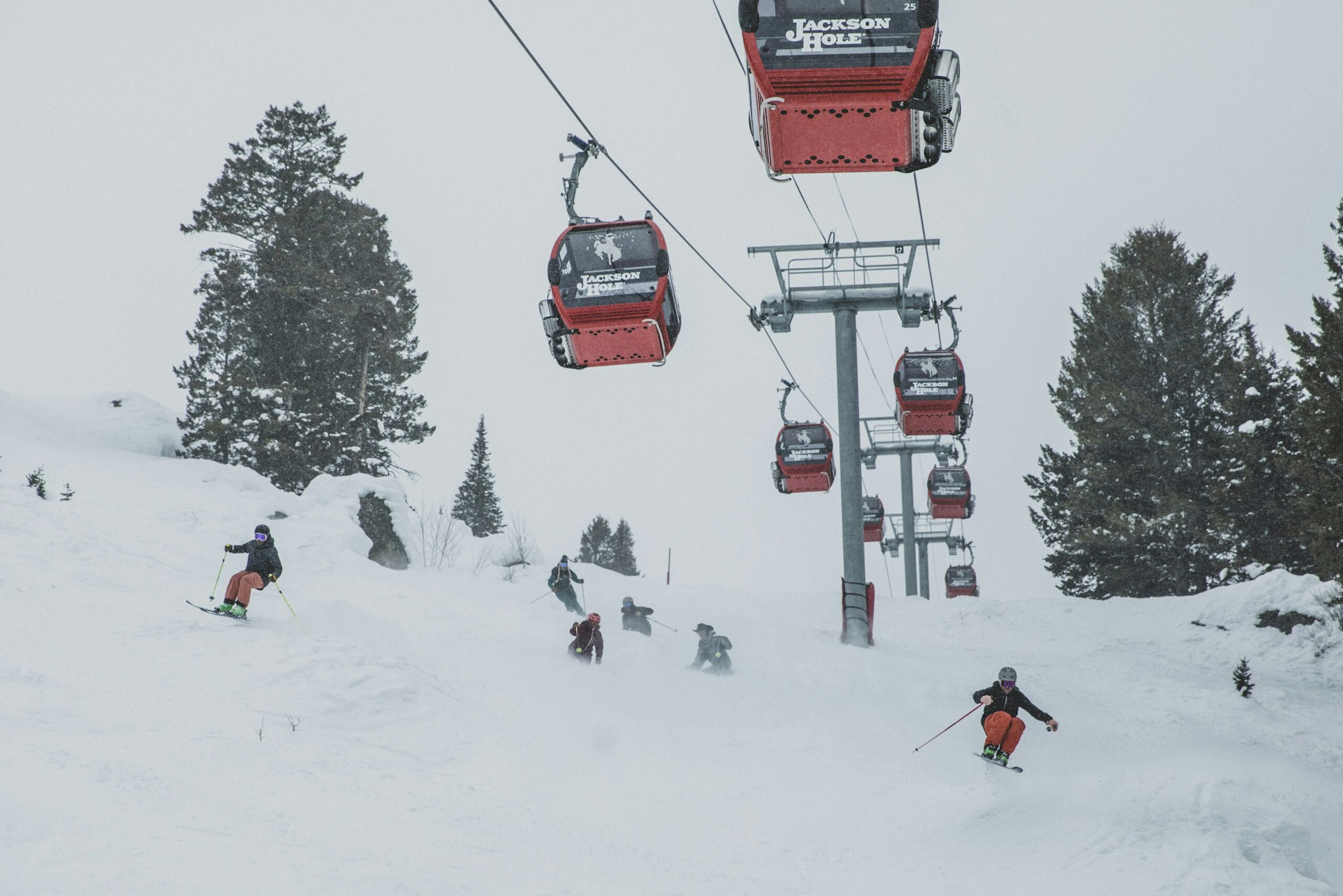 Skiers ski under the Jackson Hole gondola