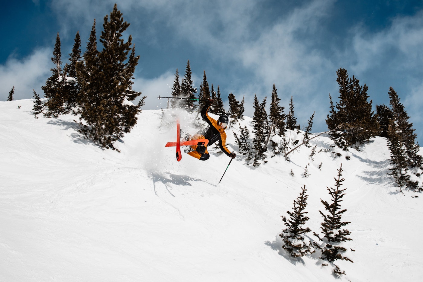 Skier catches air off a small jump on a hill