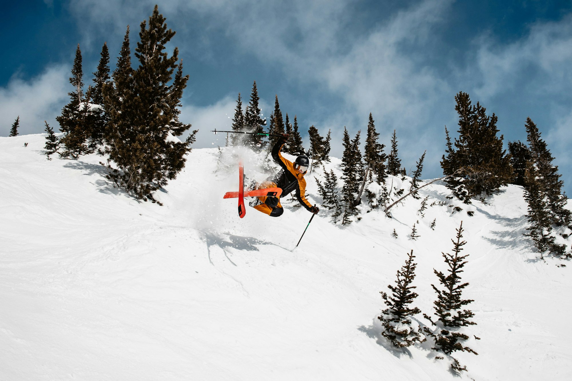 Skier catches air off a small jump on a hill