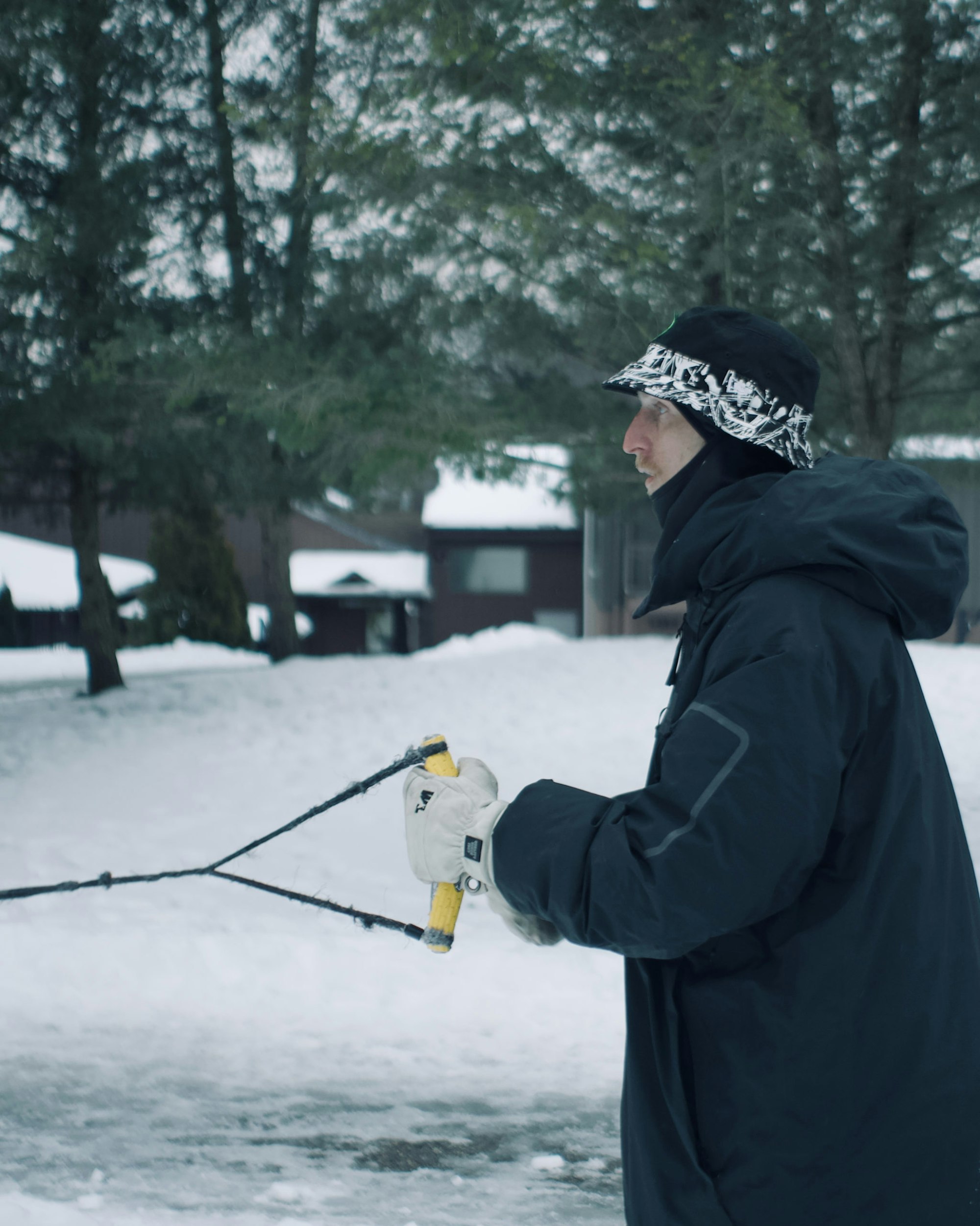 Skier holds a taut handle attached to a rope