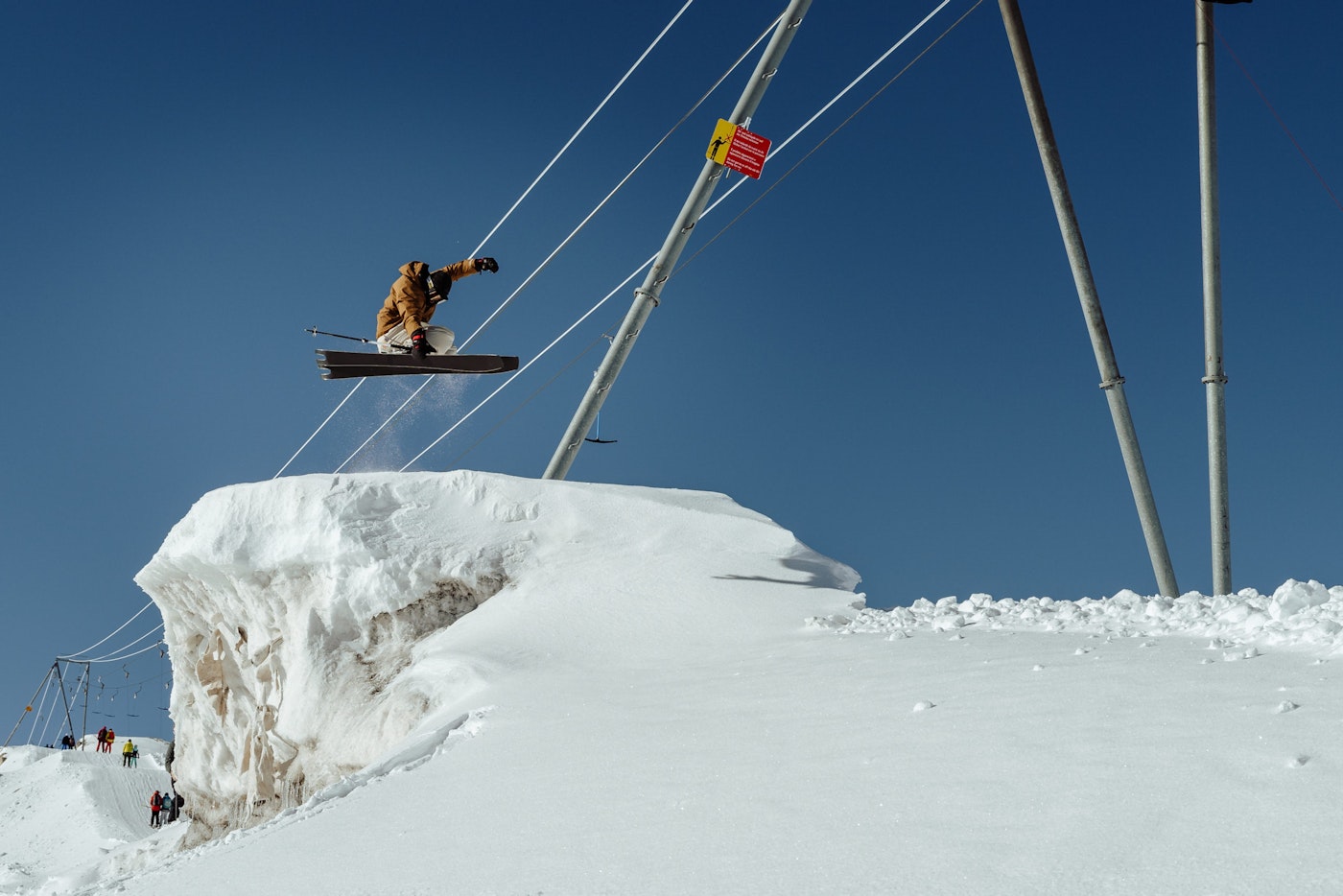 Skier catches air jumping off a wind lip in deep snow