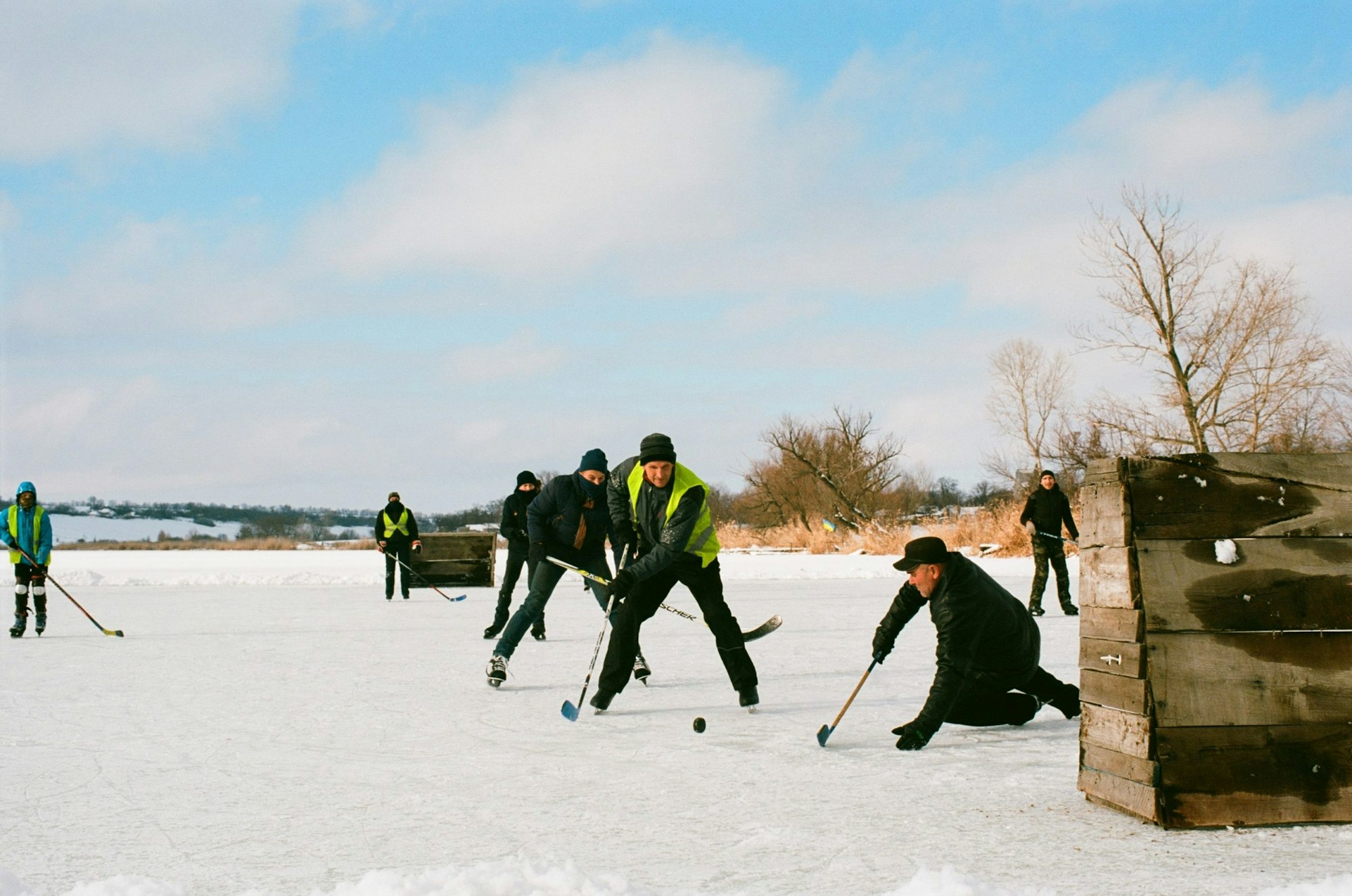 Men playing pond hockey