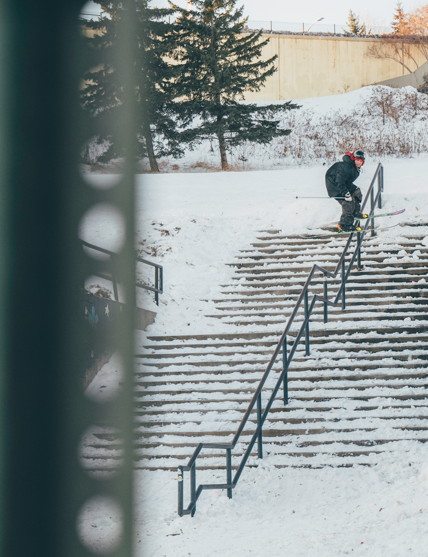 Skier Henrik Harlaut slides a rail on an outdoor staircase