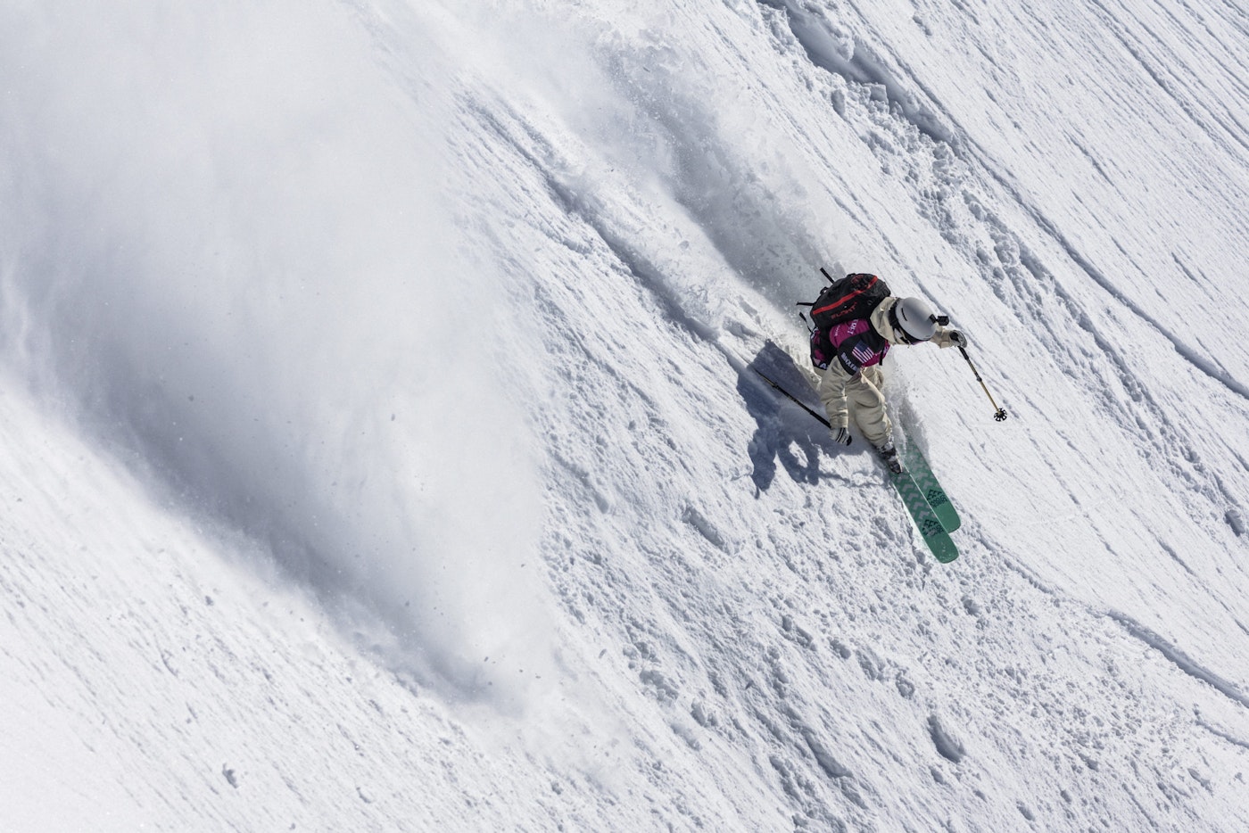 Freeride world tour skier turns down a snowy face
