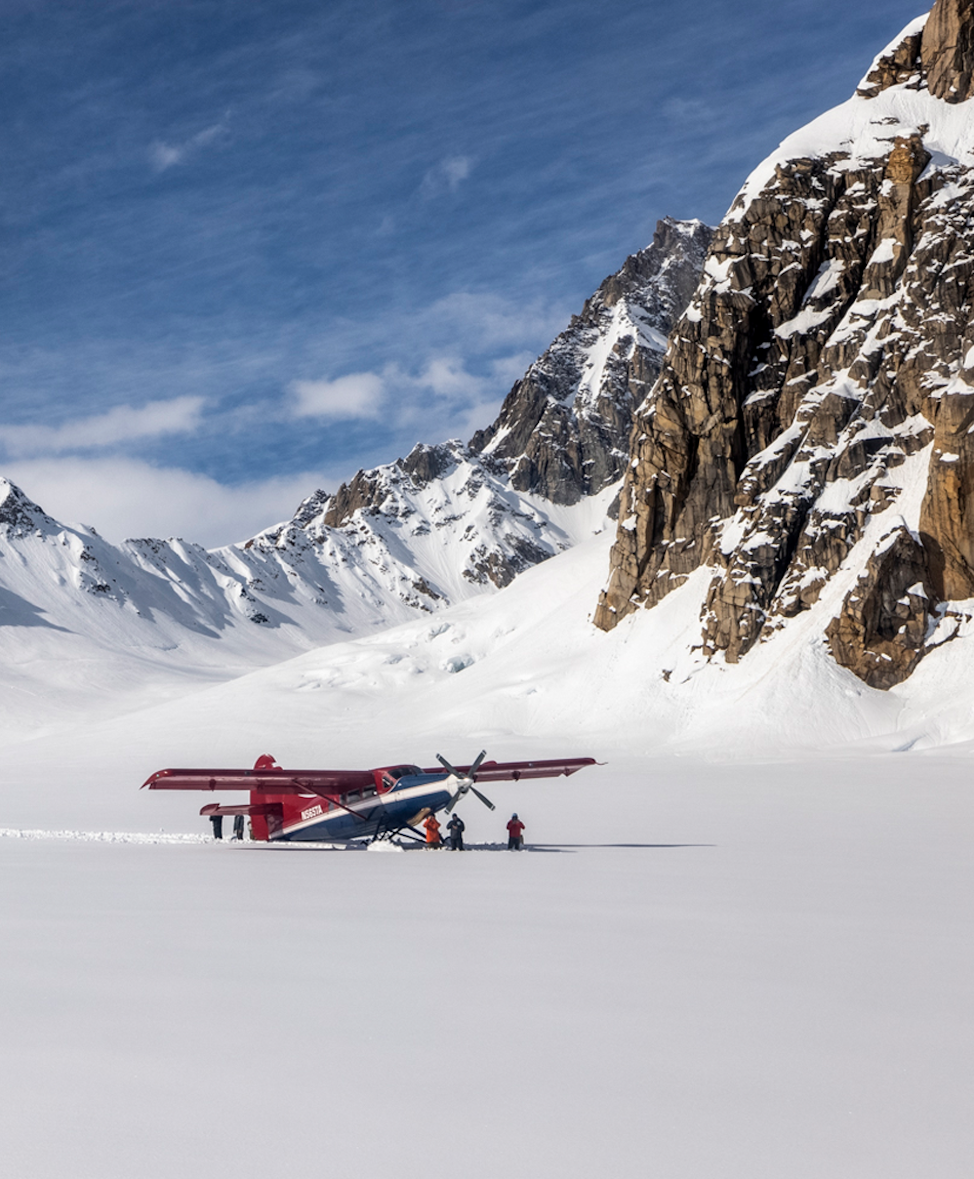 Helicopter landed in the snow in a mountain range in Alaska