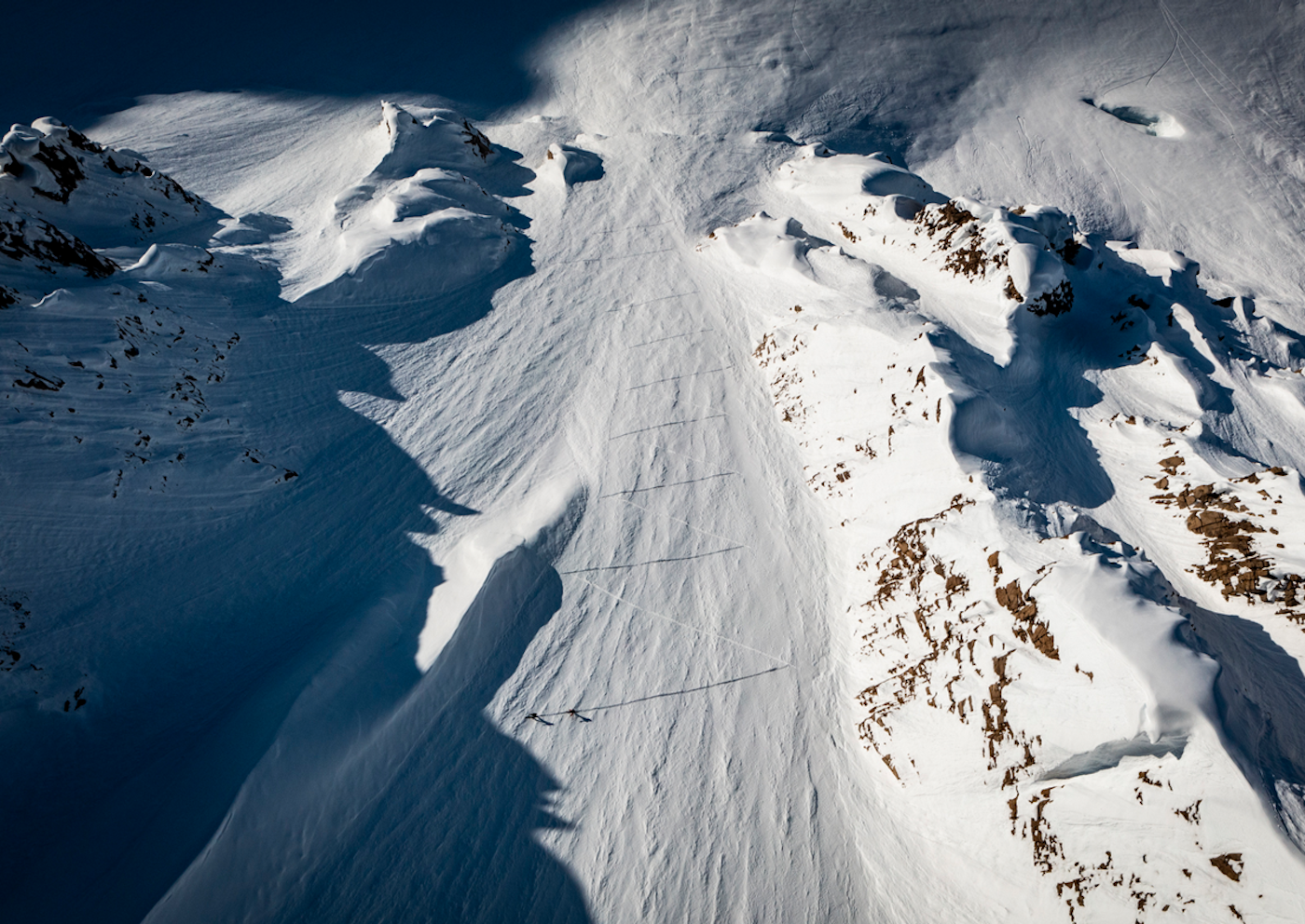 Skiers skin up the side of a mountain