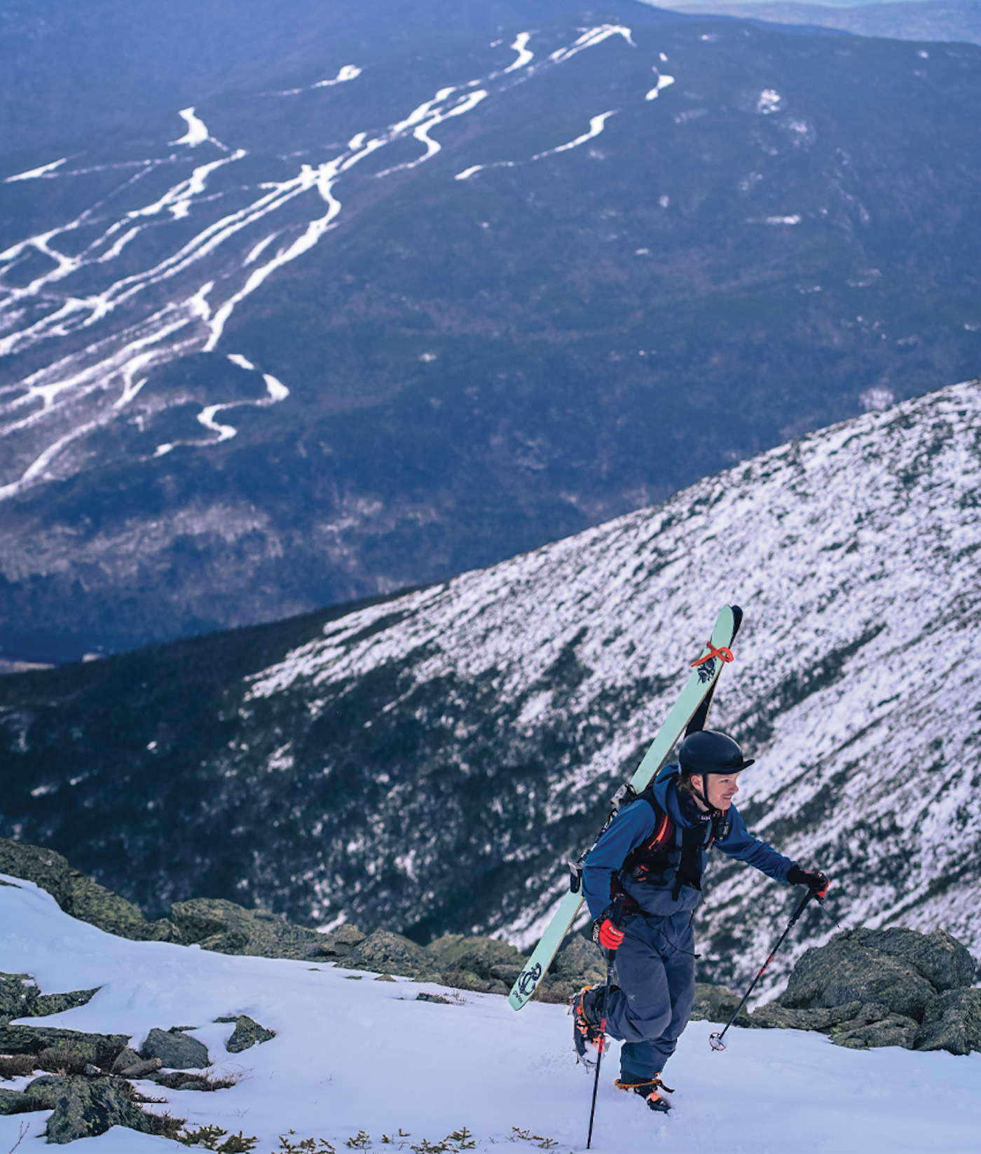 Alex Goff hikes his skis up a snowy mountain