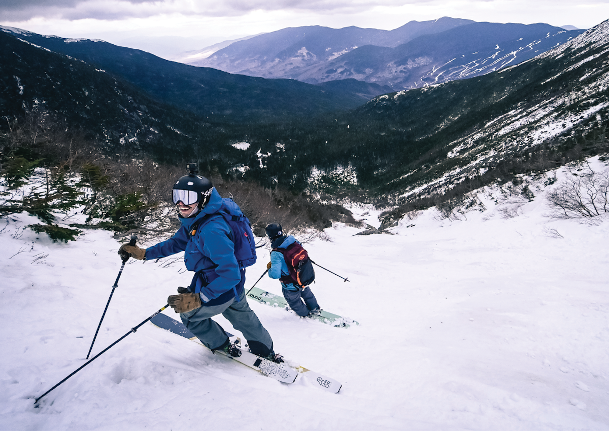 Alex Goff and Nate Trachte stand on their skis at the top of Tuckerman's Ravine