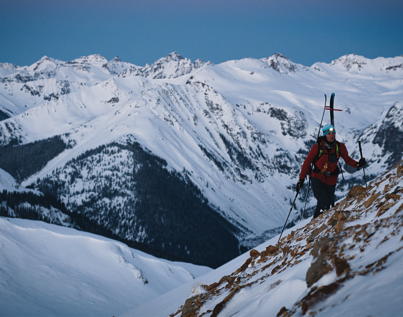Skier Connor Ryan hikes up a mountain in the snow
