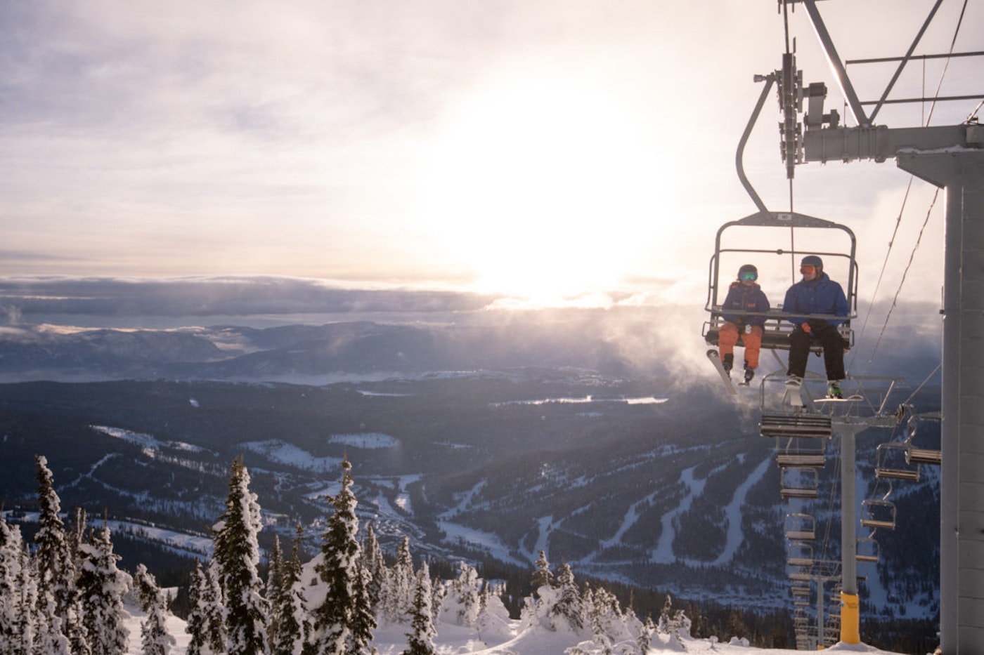 Two skiers on a chairlift in Colorado