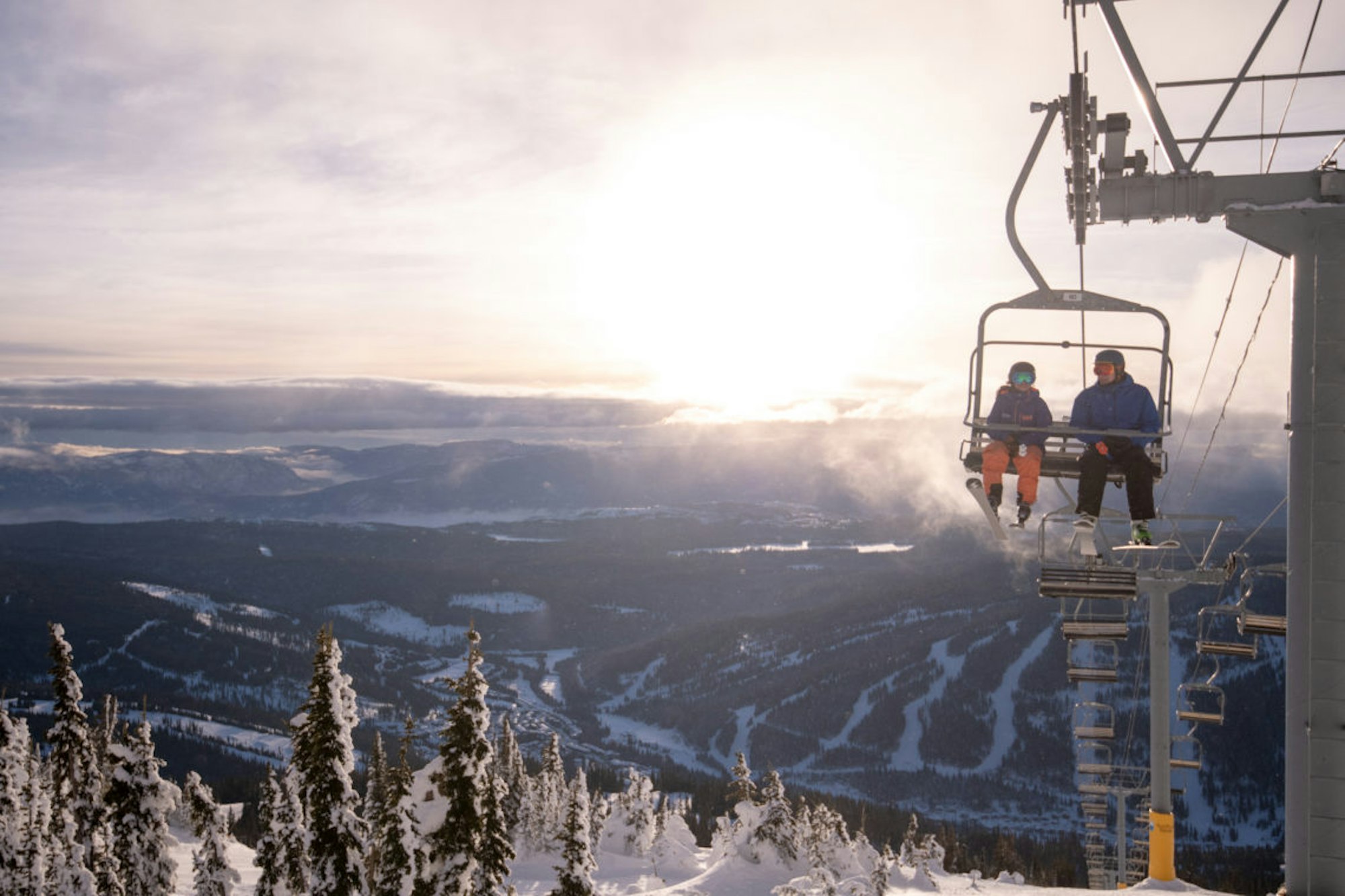 Two skiers on a chairlift in Colorado