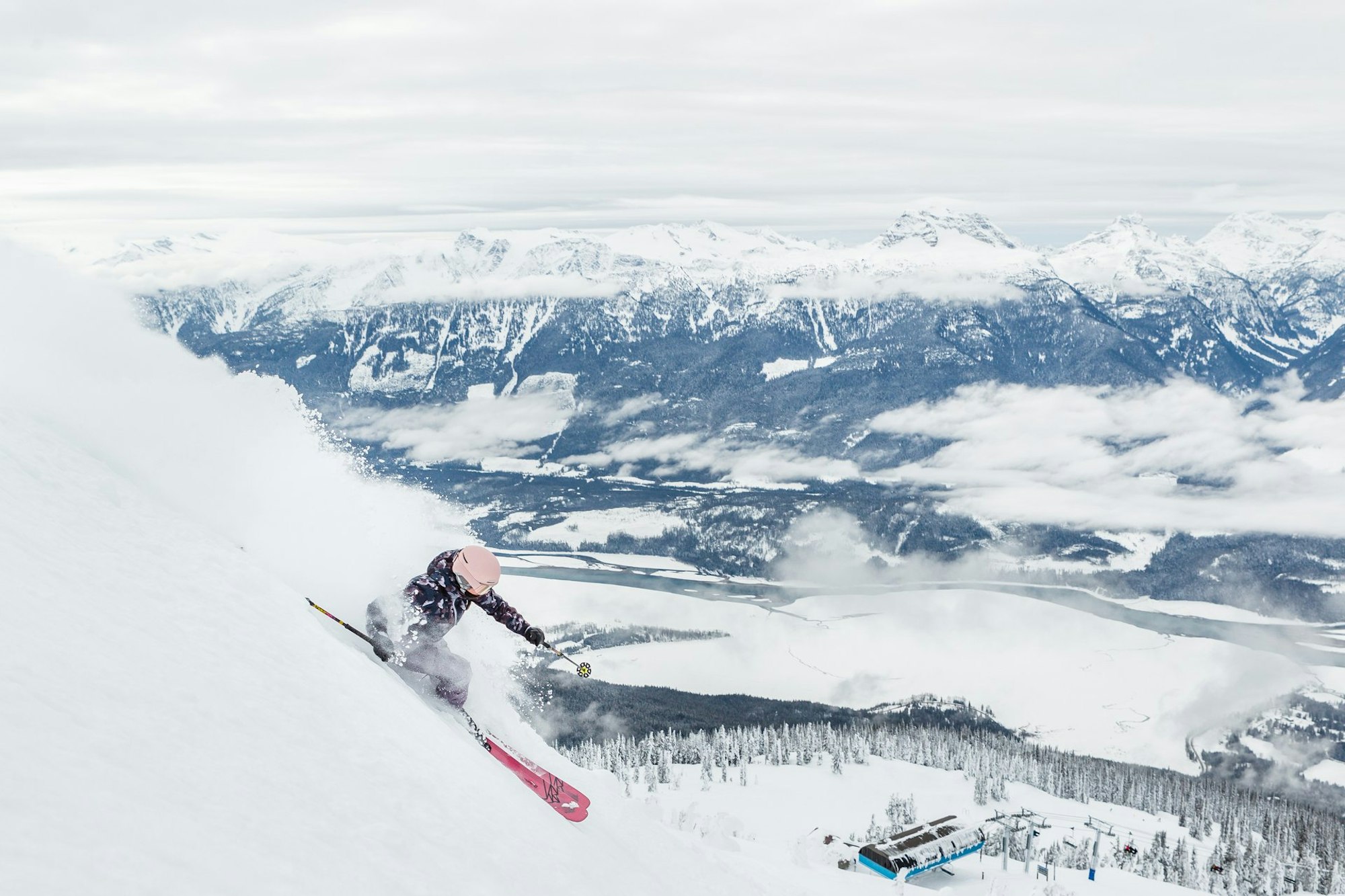 Skier skiing down a steep slope