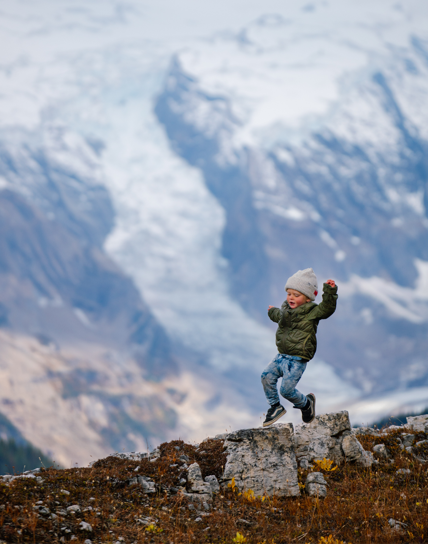 Child playing on the rocks on a mountain