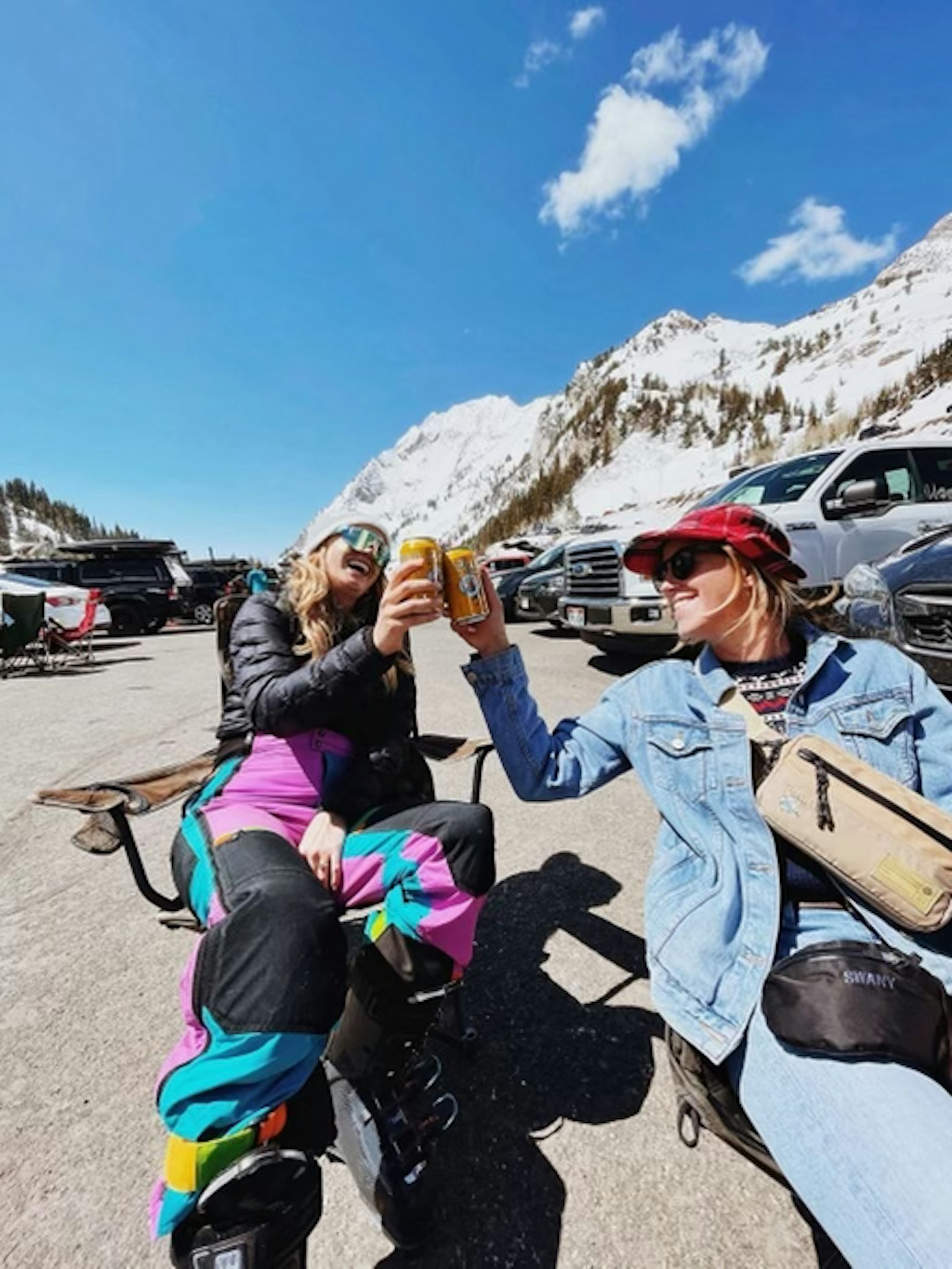 Skiers sitting in the resort parking lot