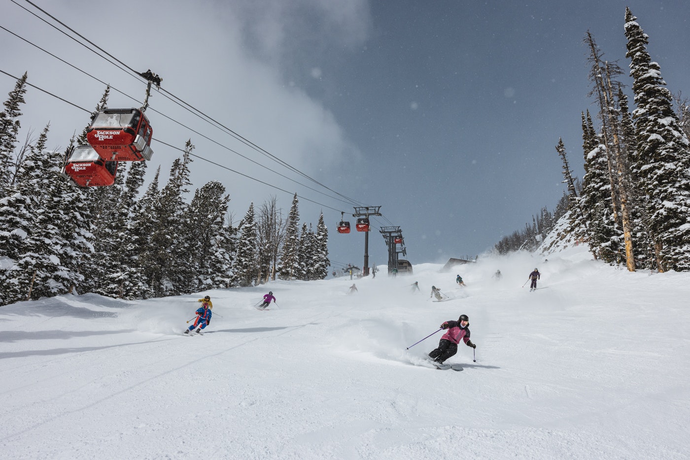 Skiers ski under the gondola at Jackson Hole Mountain Resort