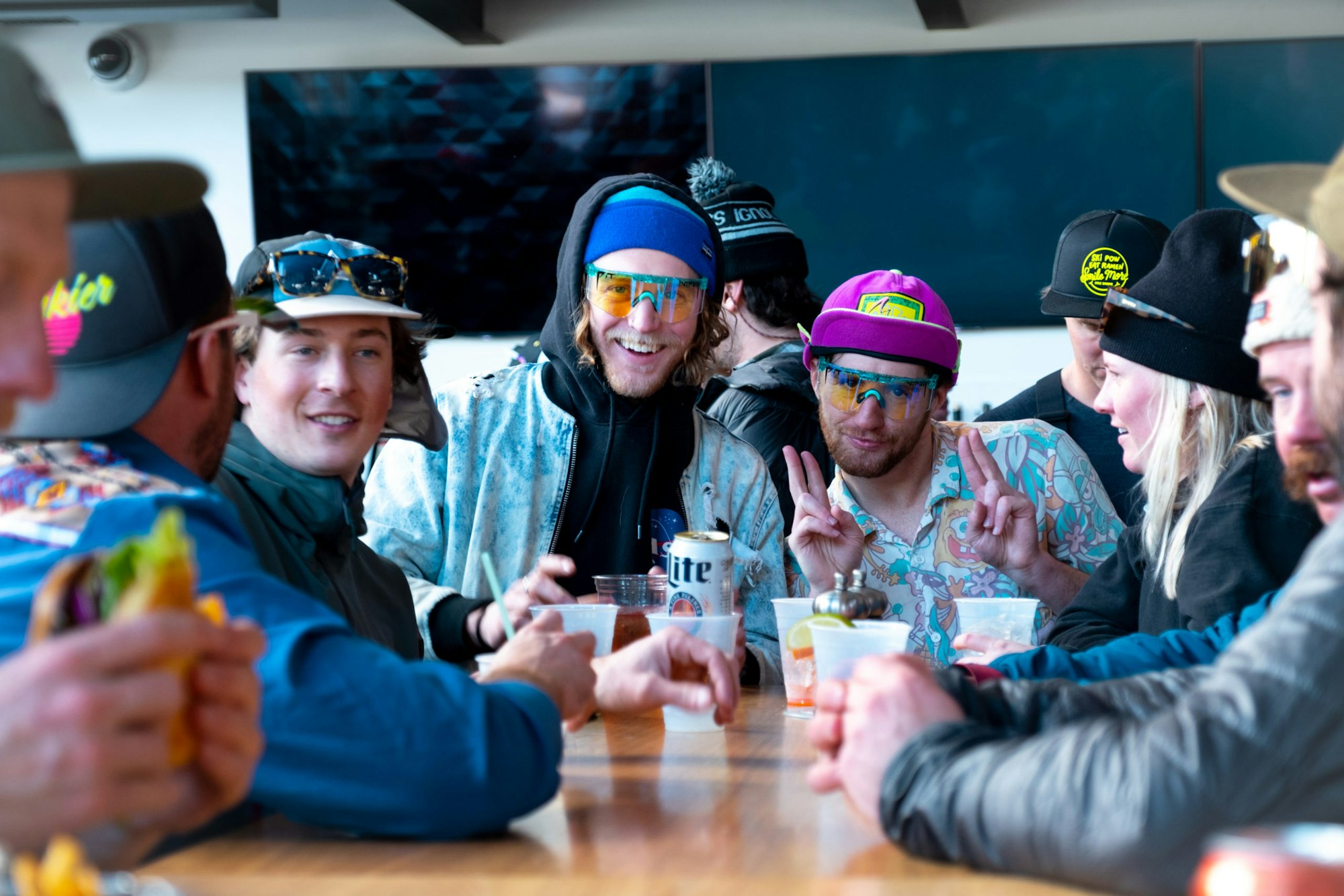 A group sits at a table drinking beer together