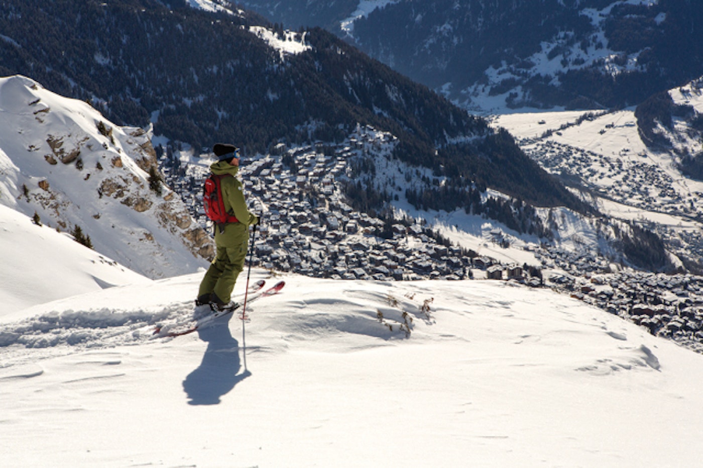 Skier standing above the town of Verbier.
