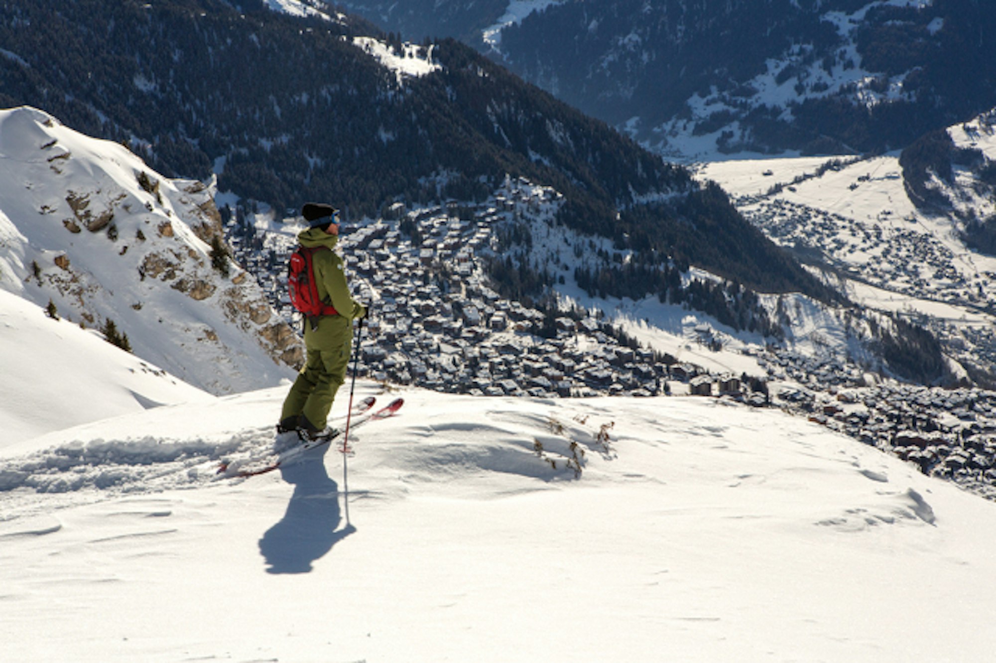 Skier standing above the town of Verbier.
