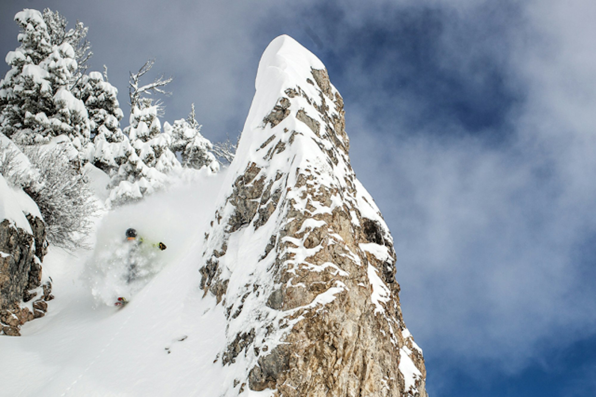 Pro skier Corey Seemann skiing deep powder.