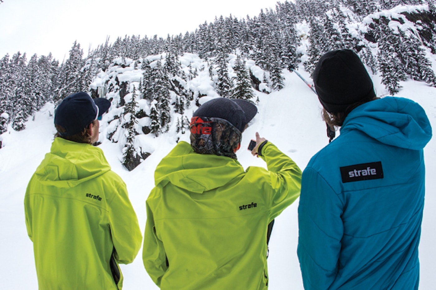 Pro skiers pointing out lines.