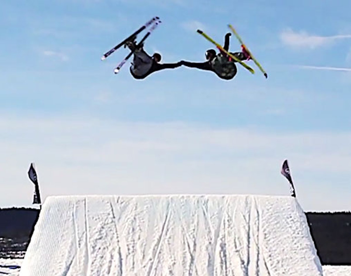 These synchronized skiers connected for well-timed, mid-air fist bump