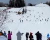 30 skiers perform tandem backflips while holding hands