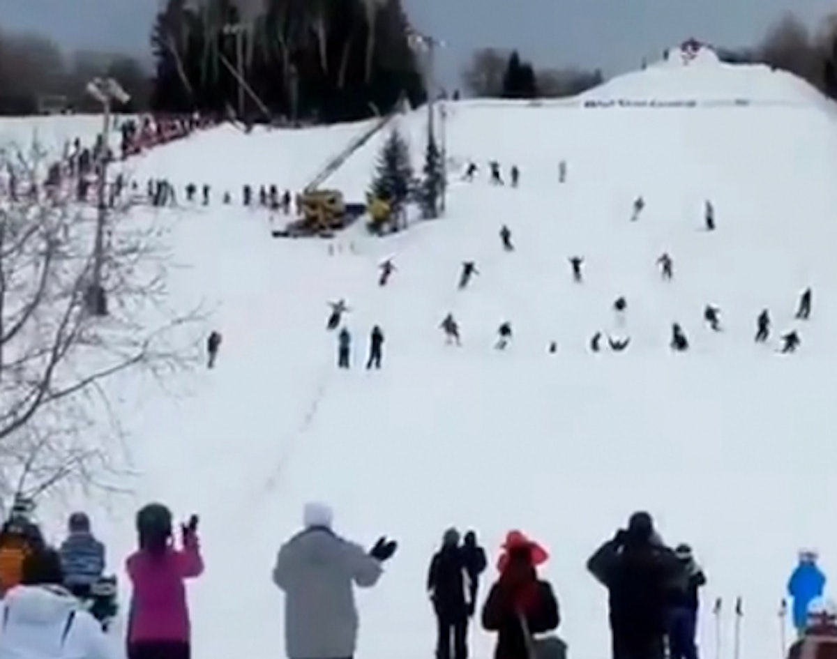 30 skiers perform tandem backflips while holding hands