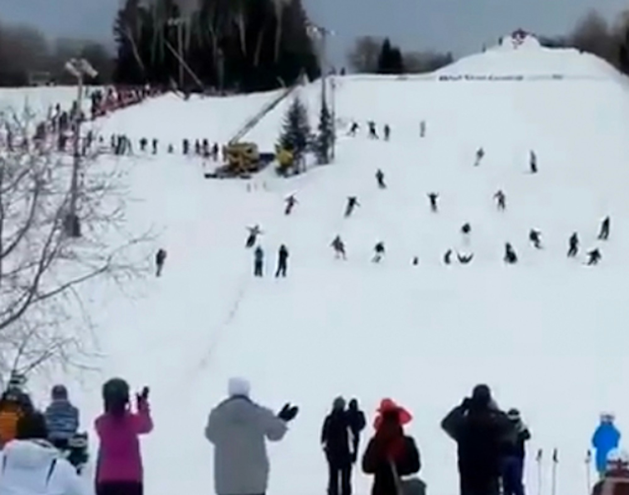 30 skiers perform tandem backflips while holding hands
