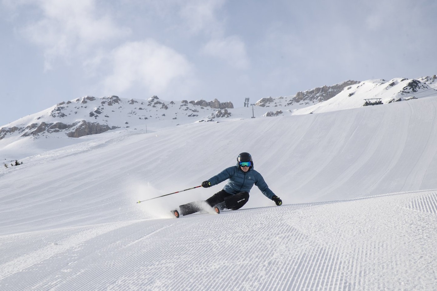 Skier skiing down groomed trail in Cortina, IT
