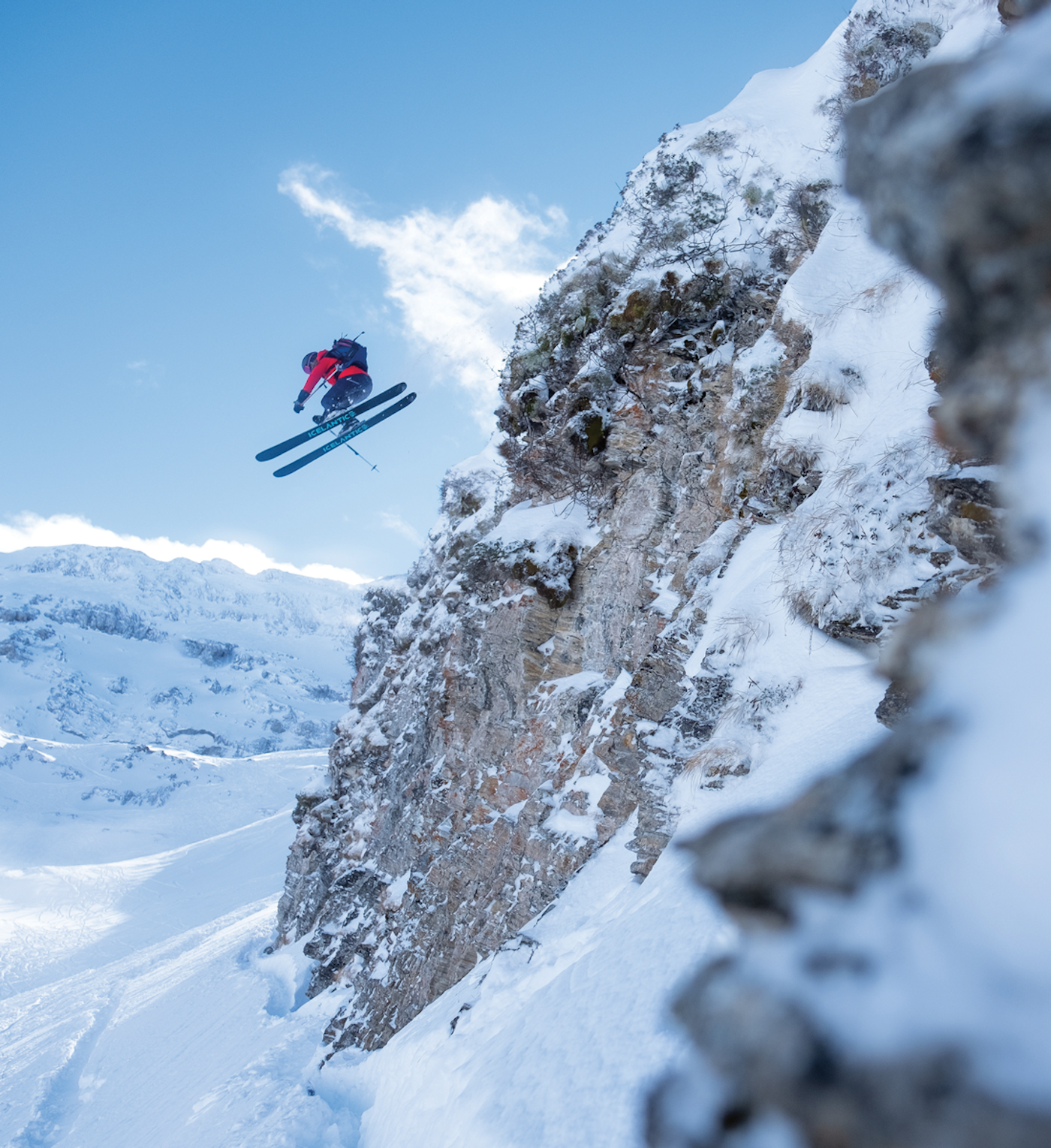 Skier Amy Davis jumping off a massive cliff on skis