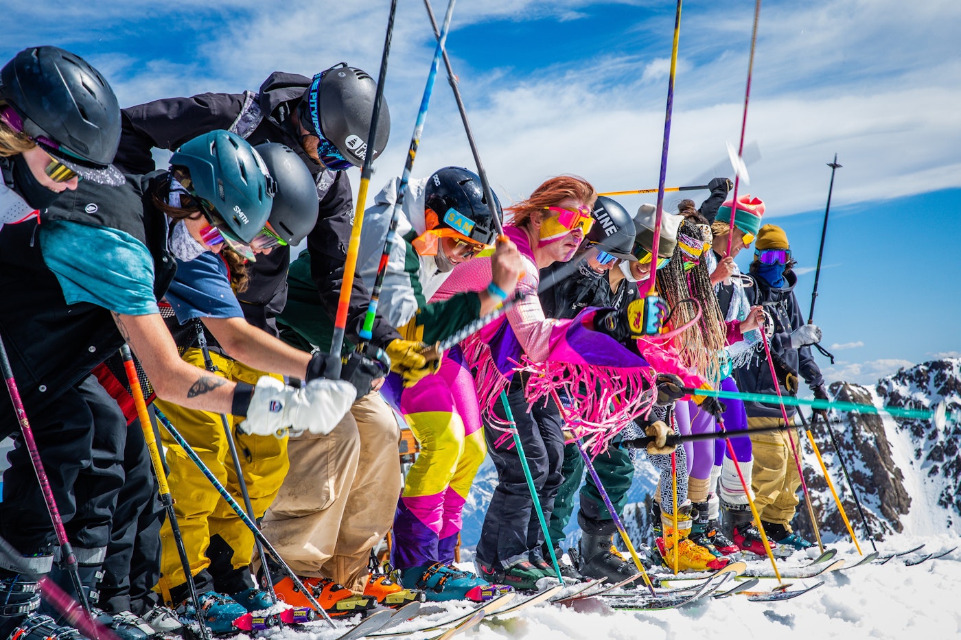 Pro skiers pole whacking a cornice